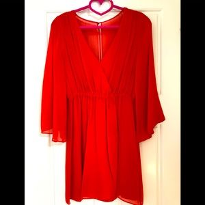 Short red/orange dress with flowy sleeves